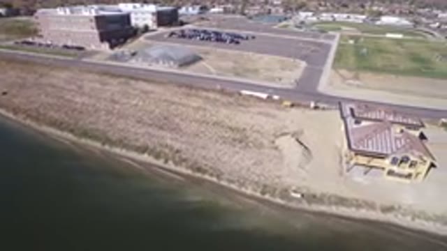 HIDDEN LAKE COLORADO-2016: Aerial View Of A Beachside Building Next To The Calm