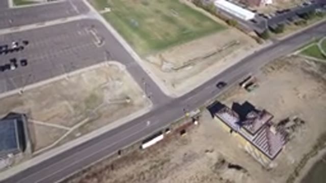HIDDEN LAKE COLORADO-2016: Car Driving Down Road Past House And Water Toward