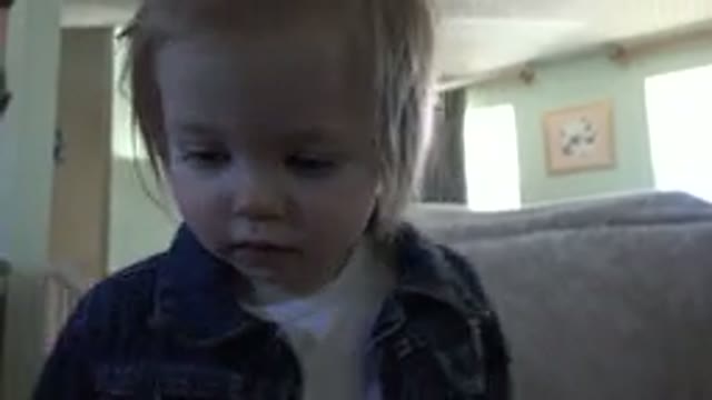 WESTMINSTER COLORADO-2016: A Little Girl Wearing Black Denim Shirt Touching Camera Lens