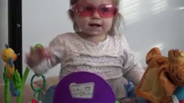 WESTMINSTER COLORADO-2016: Baby Girl With Pink Glasses At Home Playing With Toys