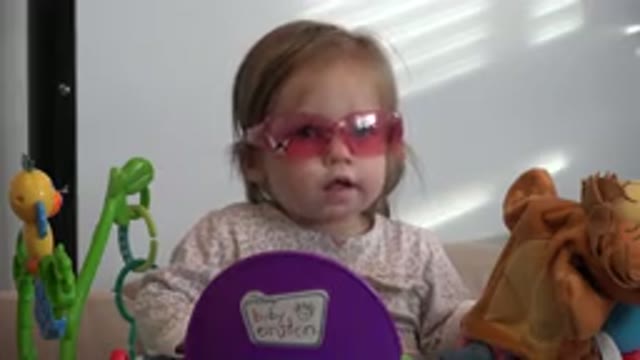 WESTMINSTER COLORADO-2016: Cute Blond Baby Girl Surrounded By Her Toys Wearing Pink