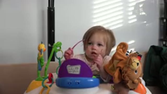 WESTMINSTER COLORADO-2016: Small Blonde Child Indoors Putting On Pink Toy