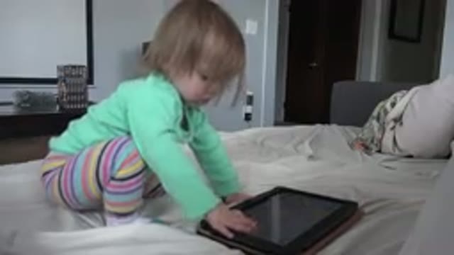 WESTMINSTER COLORADO-2016: Baby Playing With Tablet Computer On Bed