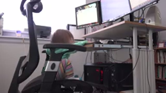 WESTMINSTER COLORADO-2016: Small Child Sat On Computer Chair In A Home Office