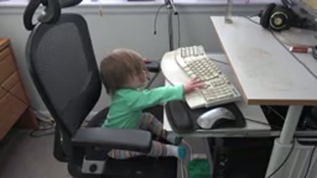 WESTMINSTER COLORADO-2016: Small Child Sitting In Office Chair Pecking At Keyboard