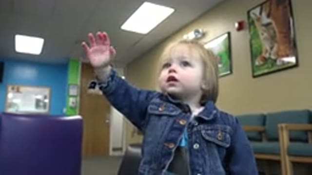 DENVER COLORADO-2016: Cute Baby Waving Hands in Jeans Jacket