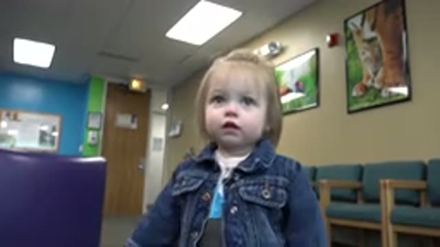 DENVER COLORADO-2016: Cute Blonde Baby Girl Gesturing in Doctor's Office Waiting Room