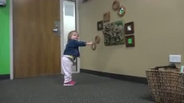 DENVER COLORADO-2016: Parent Filming Child Pointing at Plaque on Wall