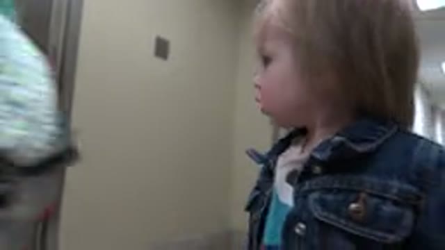 DENVER COLORADO-2016: Adults And Children Are Walking Down A Hallway One Little
