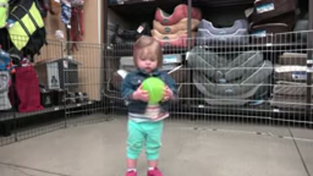 DENVER COLORADO-2016: Parent Filming Child Playing With Green Ball In Store