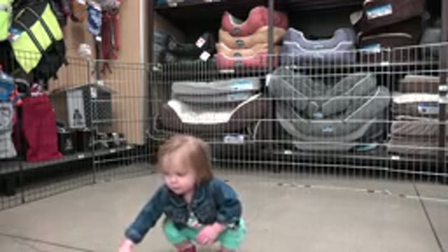 DENVER COLORADO-2016: Baby Playing With A Green Balloon In Fenced Kids Play Area