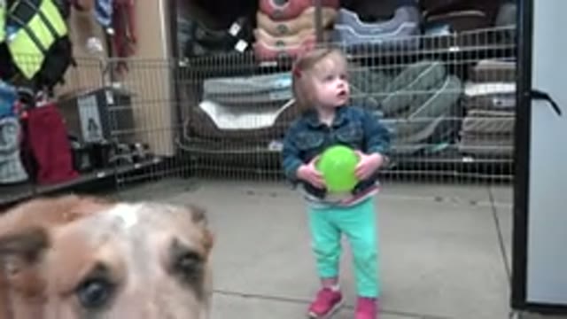 DENVER COLORADO-2016: A Cute Girl Carrying a Green Ball Standing Inside a Shop