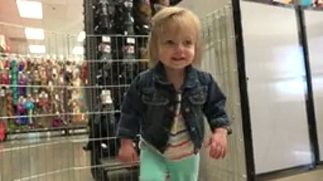 DENVER COLORADO-2016: Footage Of A Little Girl Playing With A Small Green Ball Inside A Store