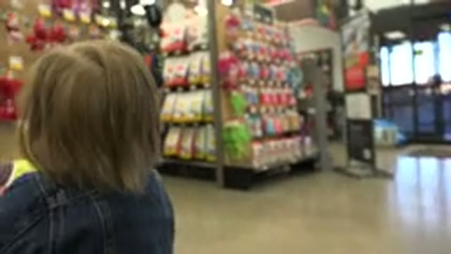 DENVER COLORADO-2016: Child Walking With Object In Hand At Market And Drops What