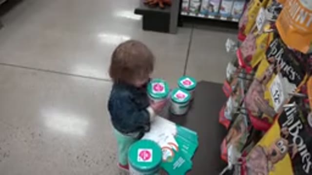 DENVER COLORADO-2016: Small Child Wearing Blue Standing Interacting With Products
