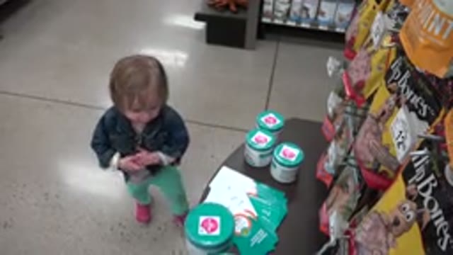 DENVER COLORADO-2016: Toddler Talking While Walking Away From Box in Shopping Mall