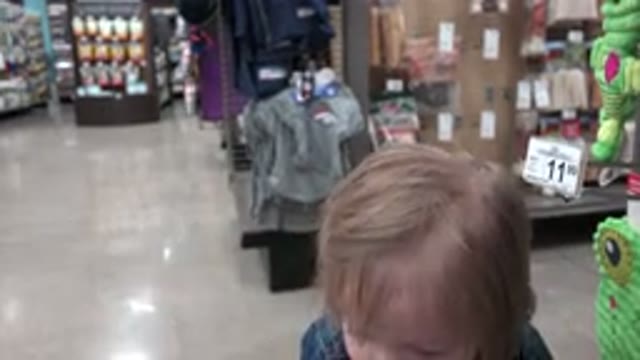 DENVER COLORADO-2016: Toddler In Department Store Picking Toy Near Aisle