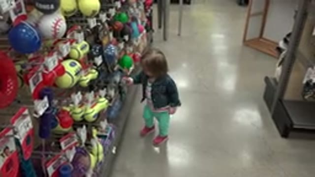 DENVER COLORADO-2016: Toddler Curiously Touching And Looking At Toys In The Toy Aisle