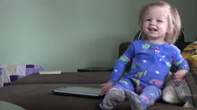 WESTMINSTER COLORADO-2016: Blonde Baby Girl Laughing Near A Tablet On A Sofa