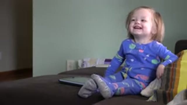 WESTMINSTER COLORADO-2016: Cute Blonde Baby Girl Sitting On A Couch Laughing In