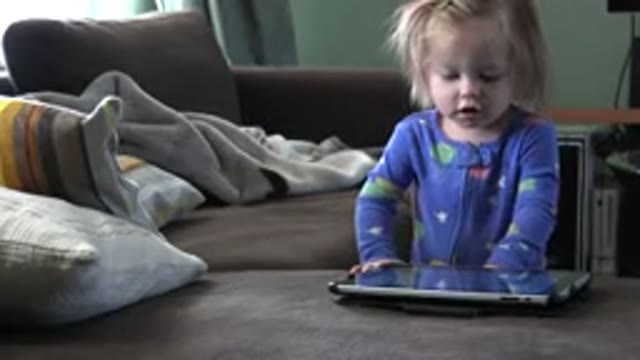WESTMINSTER COLORADO-2016: White Toddler Tapping Tablet in Living Room with Left Hand