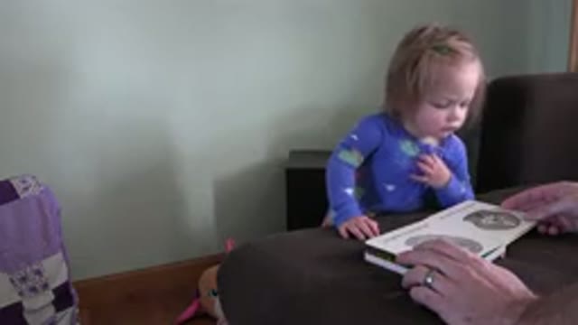 WESTMINSTER COLORADO-2016: Small Baby in Blue Pajamas Looks at a Book with Mom