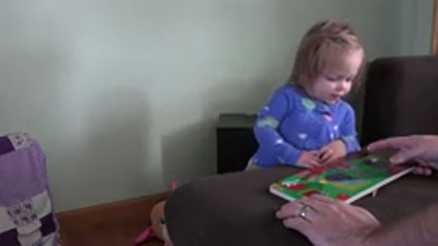 WESTMINSTER COLORADO-2016: Little Girl Is Looking At A Child Book