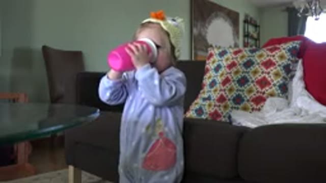 WESTMINSTER COLORADO-2016: Small Baby Wearing Purple Pajamas Drinking Happily