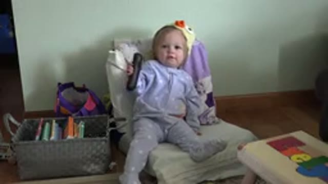 WESTMINSTER COLORADO-2016: A Cute Little Girl Sitting On A Chair And Playing