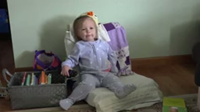WESTMINSTER COLORADO-2016: Baby Sitting On A Chair And Holding A TV Remote