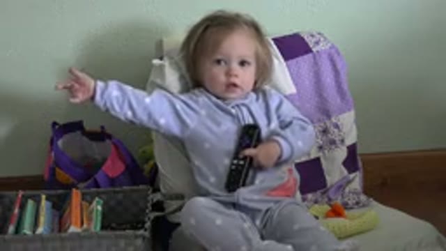 WESTMINSTER COLORADO-2016: A Little Girl Sitting in a Chair Holding a Remote