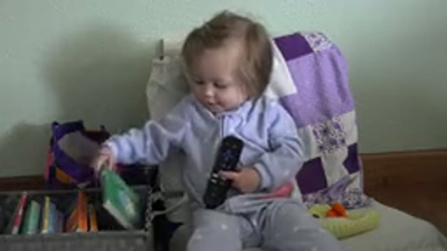 WESTMINSTER COLORADO-2016: Female Toddler Sitting and Holding Remote Control