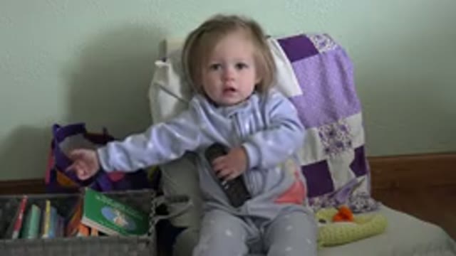 WESTMINSTER COLORADO-2016: Small Baby Girl Holding A Remote Control Looking