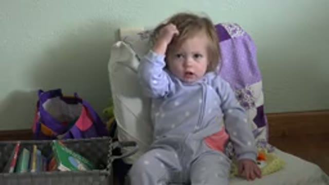 WESTMINSTER COLORADO-2016: Toddler Wearing Pajamas Sits On Couch Next To Basket