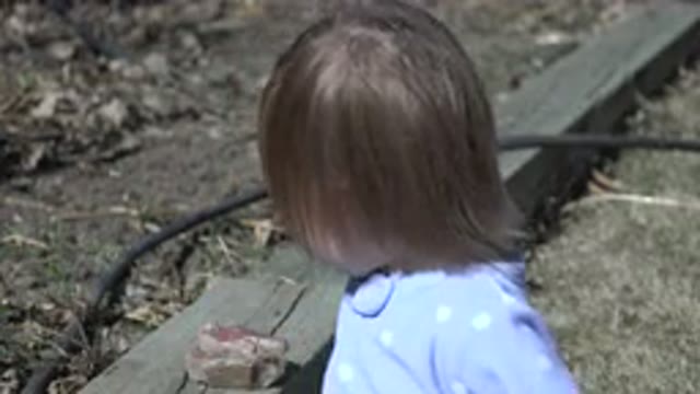 WESTMINSTER COLORADO-2016: Young Child With Long Hair Plays With Sticks And Rocks