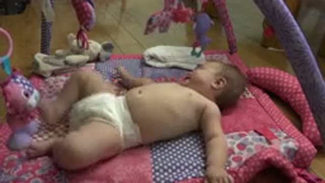 WESTMINSTER COLORADO-2015: Small Baby Wearing A Nappy Laying On A Carpet On The Floor