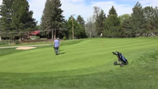 DENVER COLORADO-2015: Two Men On A Golf Course Setting Up For A Shot