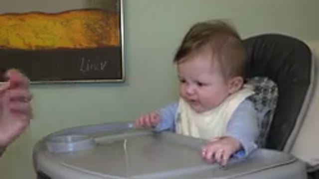 WESTMINSTER COLORADO-2015: Parent Feeding Little Baby Sitting On A High Chair