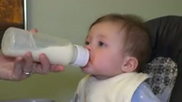 WESTMINSTER COLORADO-2015: Parent Feeding Baby Bottle To Child's Mouth