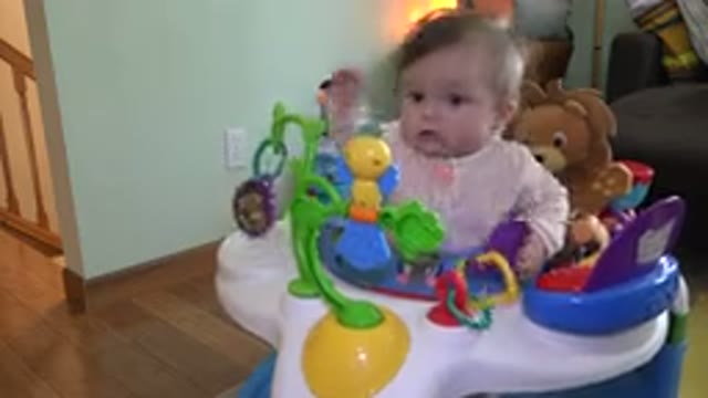 WESTMINSTER COLORADO-2015: Cute Baby Girl Playing With Toys In Her Baby Walker