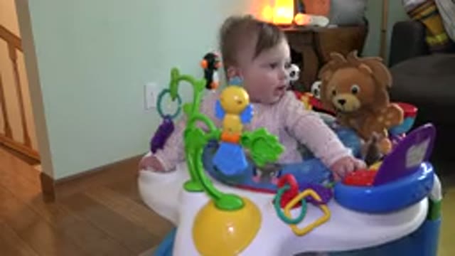 WESTMINSTER COLORADO-2015: A Cute Little Toddler Playing In His Bouncer With A Teddy Bear
