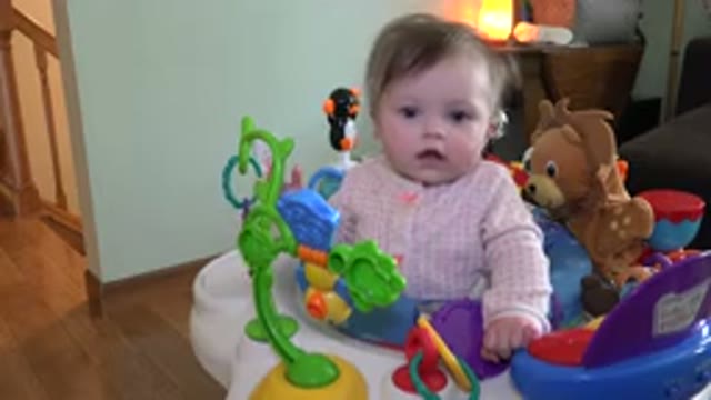WESTMINSTER COLORADO-2015: Baby Wearing A Pink Outfit Playing With An Activity Chair