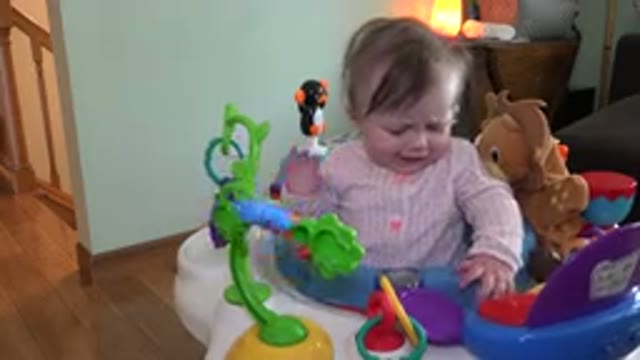 WESTMINSTER COLORADO-2015: An Upset Toddler Sitting in Her Bouncer Holding a Teddy Bear