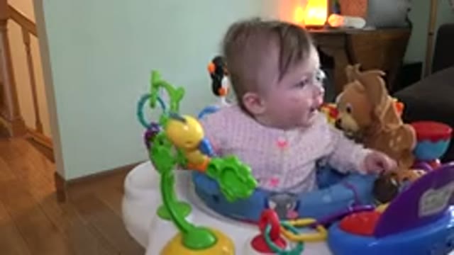 WESTMINSTER COLORADO-2015: Little Girl Sitting In A Baby Walker And Playing With Stuffed Animals