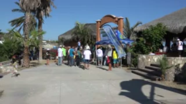 PLAYITA BCS MEXICO-2017: A Child Runs Behind People Looking At Something In A