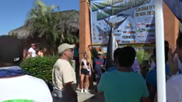 PLAYITA BCS MEXICO-2017: People Viewing Hanging Body Of Shark Beside A Thatched Cottage