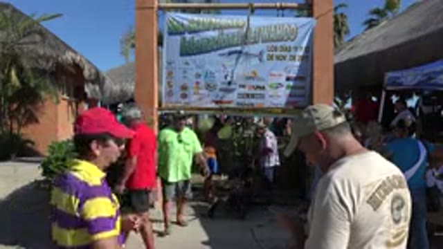 PLAYITA BCS MEXICO-2017: Lime Green Shirt Man Waits in Long Line on a Hot Day