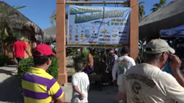 PLAYITA BCS MEXICO-2017: People Working Under a Big Hoarding and Others Roaming