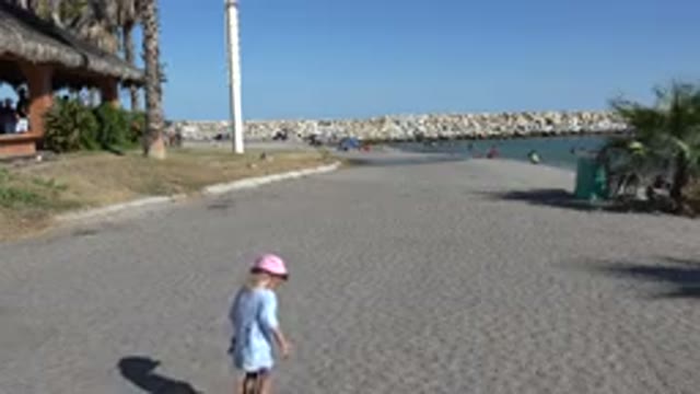 PLAYITA BCS MEXICO-2017: A Girl Wearing A Long Blue Shirt And A Pink Hat Walking