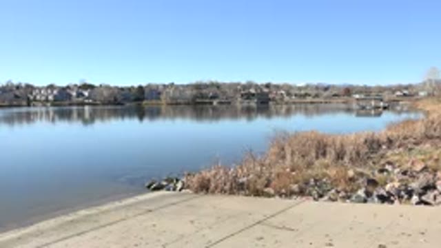 HIDDEN LAKE COLORADO-2017: Boat Ramp At Lake While Cars Drive By In The Distance